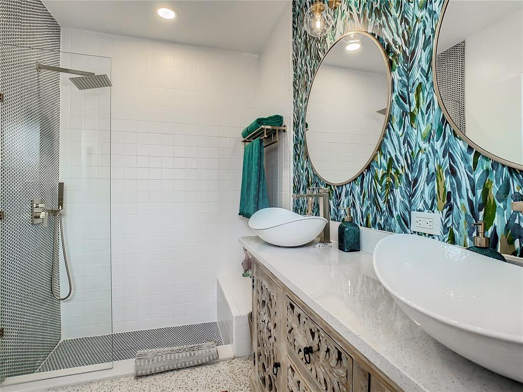 3228 Webber Street Sarasota, FL 34239 - Photo 22 of 39 a bathroom with a double vanity sink and mirror