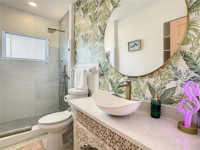 a bathroom with a sink toilet and a mirror