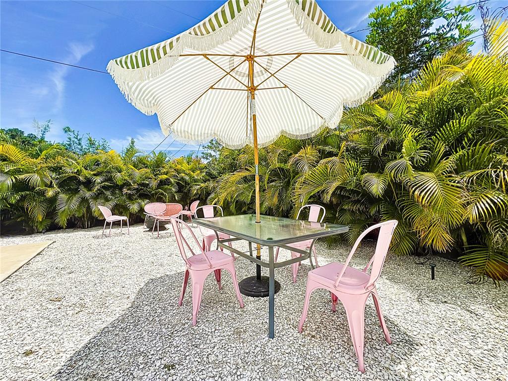 3228 Webber Street Sarasota, FL 34239 - Photo 36 of 39 a patio with a table and chairs