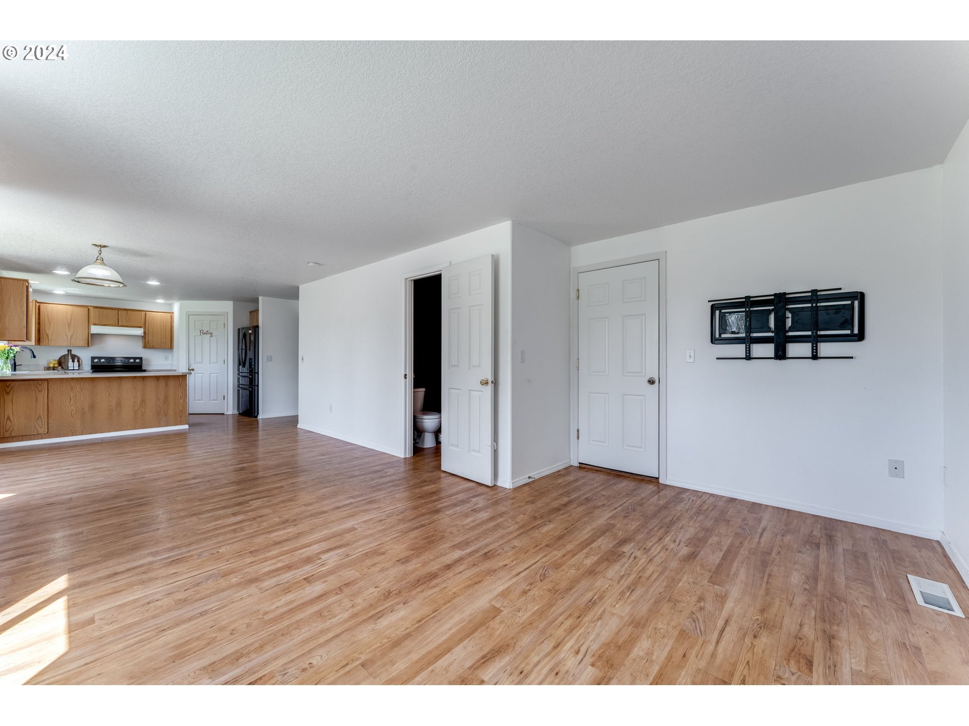805 Raven Drive Ridgefield, WA 98642 - Photo 12 of 35 a view of a kitchen with wooden floor and a kitchen