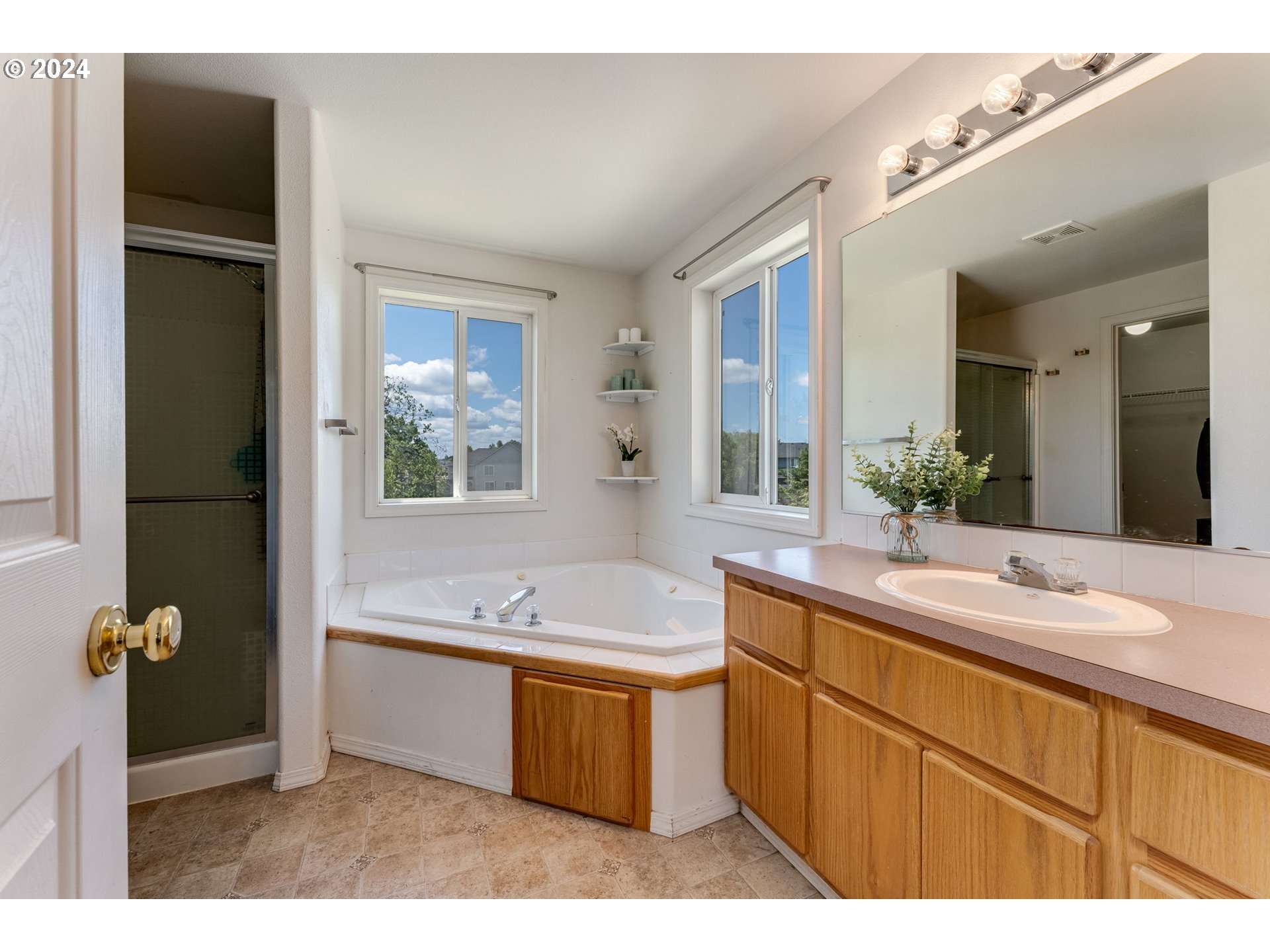 805 Raven Drive Ridgefield, WA 98642 - Photo 20 of 35 a bathroom with a granite countertop sink mirror and a bathtub