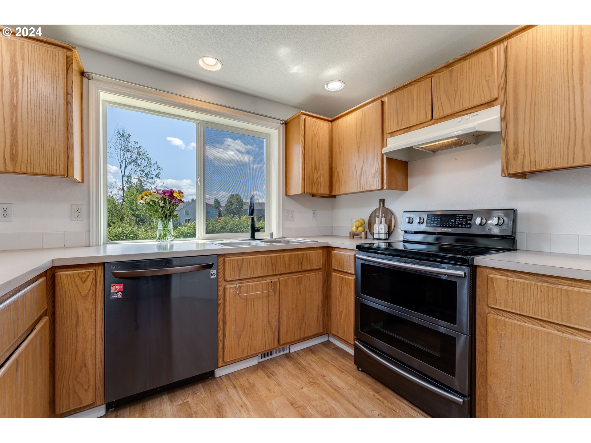 805 Raven Drive Ridgefield, WA 98642 - Photo 9 of 35 a kitchen with stainless steel appliances granite countertop a stove a sink and a microwave