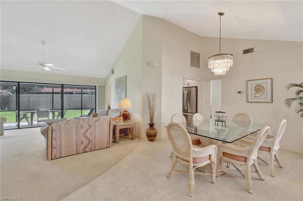 731 Reef Point Circle Naples, FL 34108 - Photo 11 of 47 a view of a dining room with furniture and chandelier