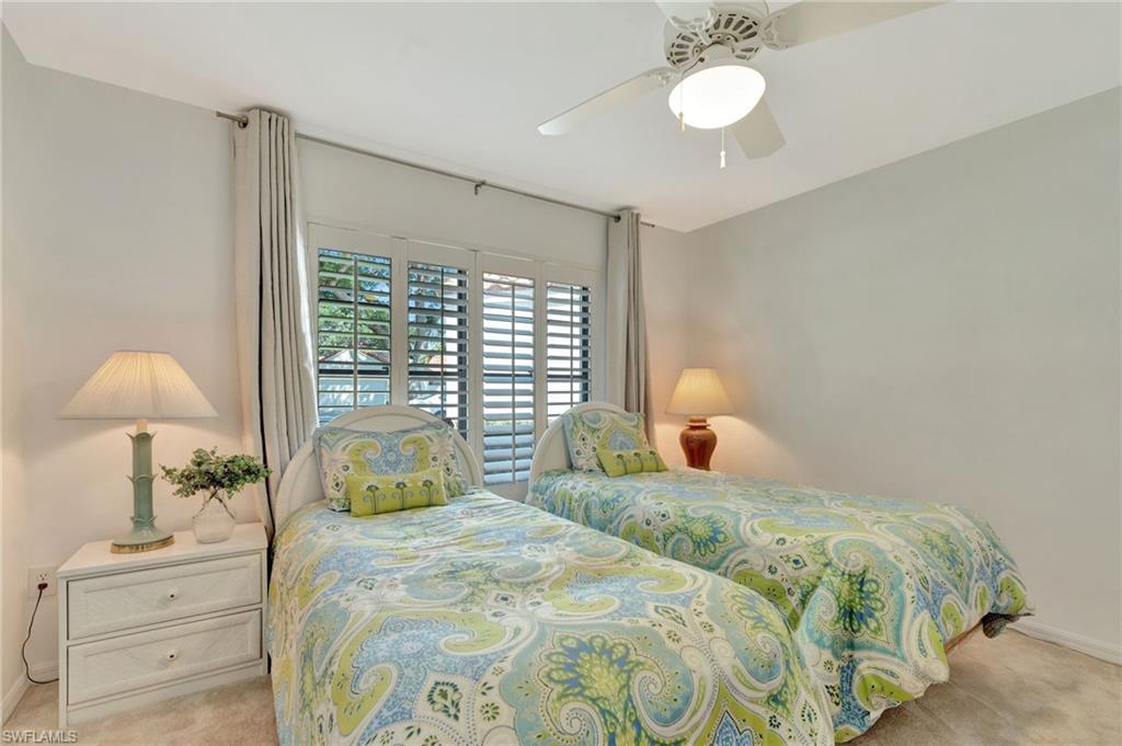 731 Reef Point Circle Naples, FL 34108 - Photo 17 of 47 a bedroom with a bed and a window