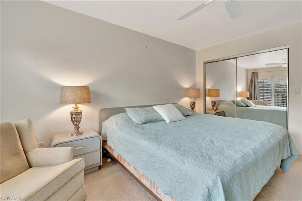 731 Reef Point Circle Naples, FL 34108 - Photo 25 of 47 a bedroom with bed and window