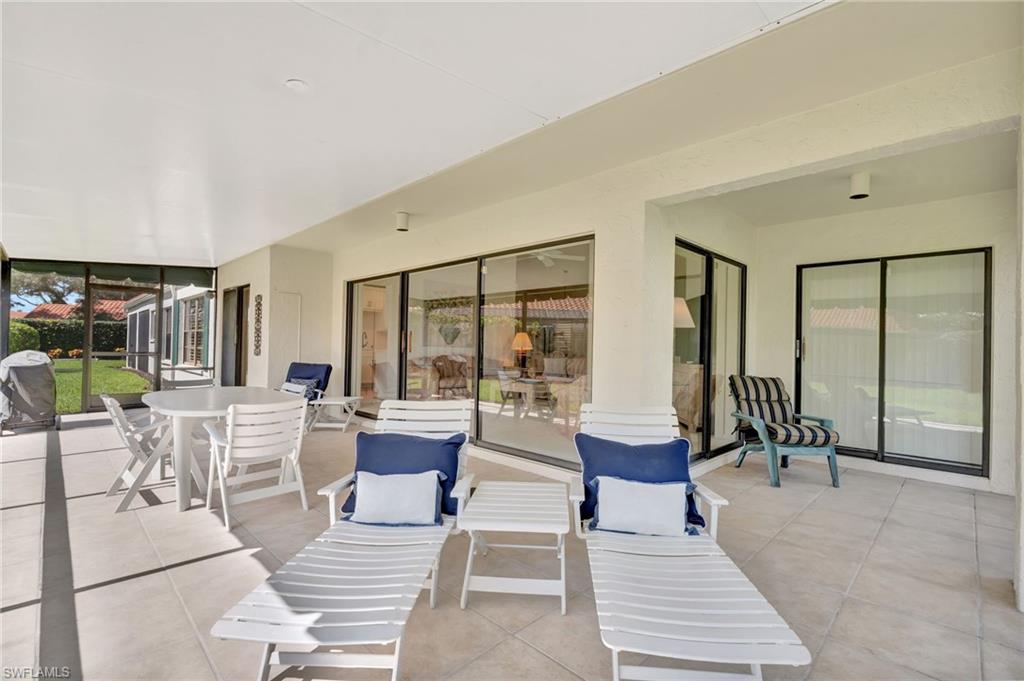 731 Reef Point Circle Naples, FL 34108 - Photo 29 of 47 a living room with couches and large glass door with rug floor