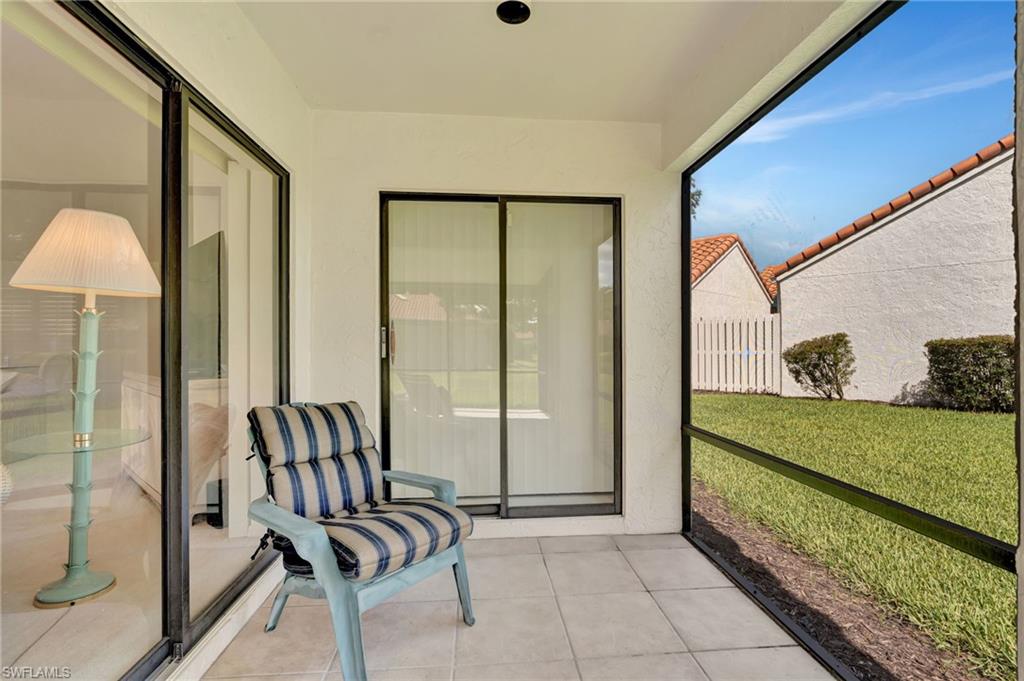 731 Reef Point Circle Naples, FL 34108 - Photo 30 of 47 a view of a porch with furniture and floor to ceiling window