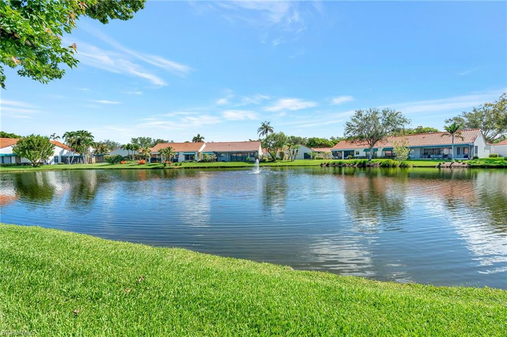731 Reef Point Circle Naples, FL 34108 - Photo 32 of 47 a view of a lake with houses in the back