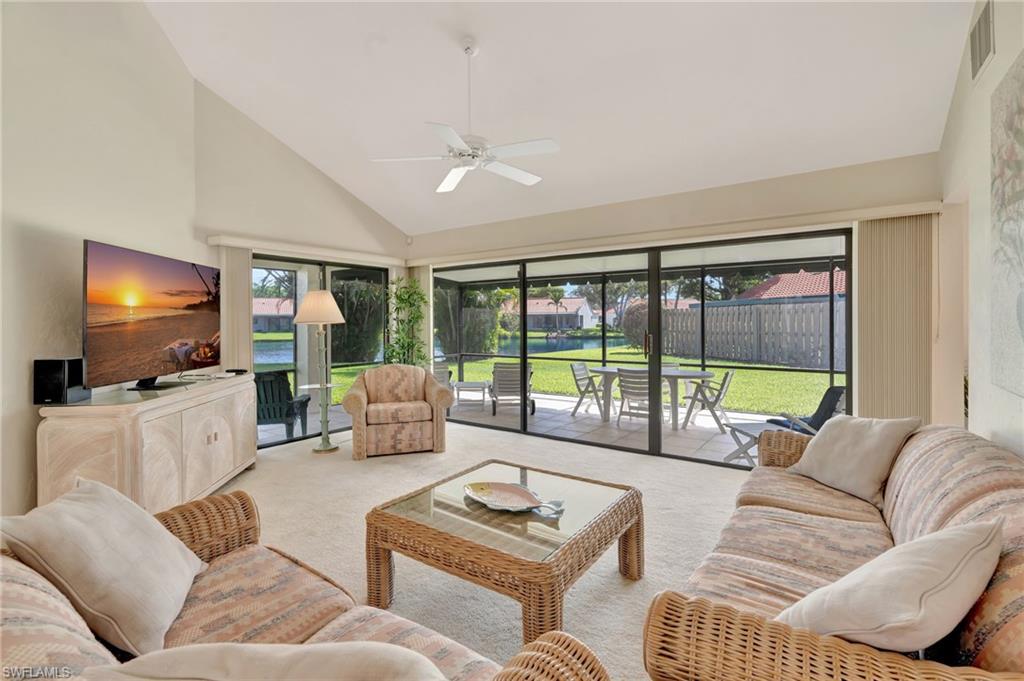 731 Reef Point Circle Naples, FL 34108 - Photo 4 of 47 a living room with furniture and a flat screen tv