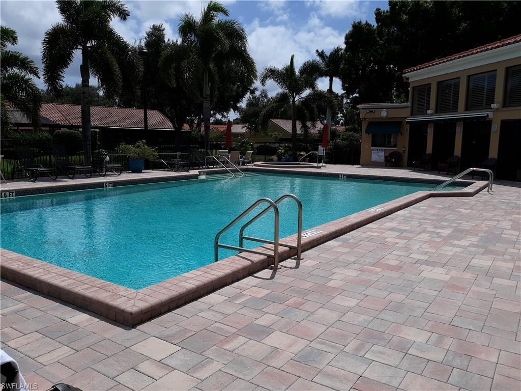 731 Reef Point Circle Naples, FL 34108 - Photo 43 of 47 a view of a swimming pool with a lounge chairs