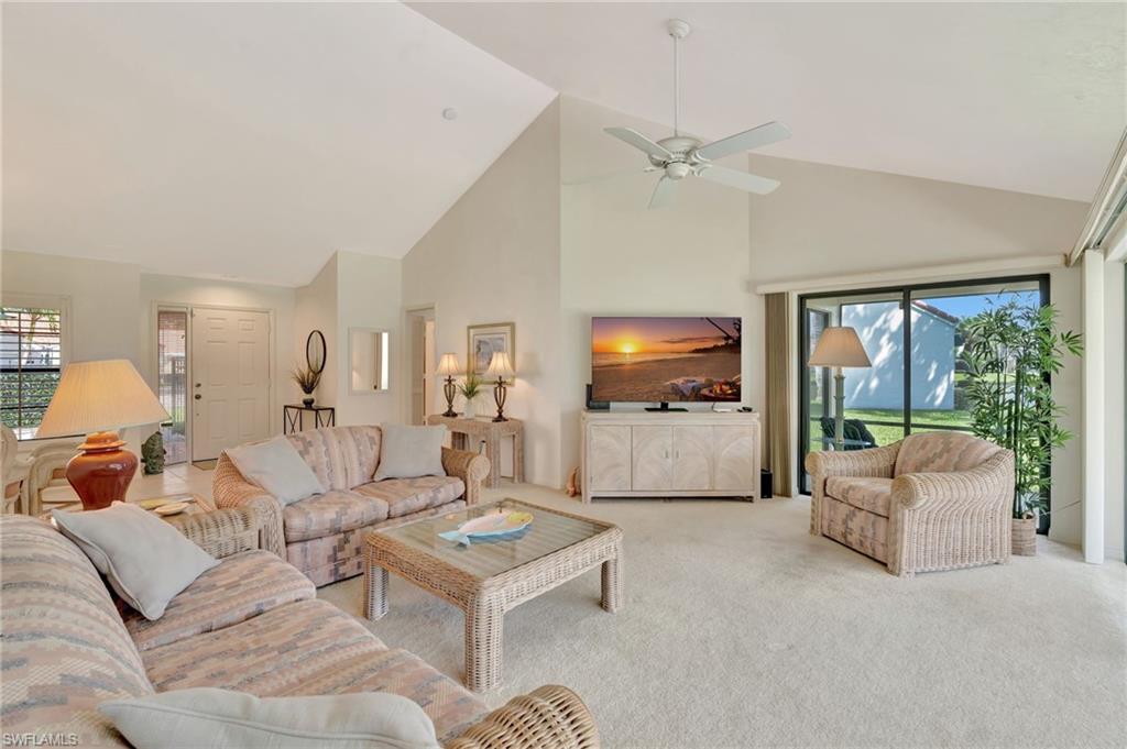 731 Reef Point Circle Naples, FL 34108 - Photo 6 of 47 a living room with furniture and a flat screen tv