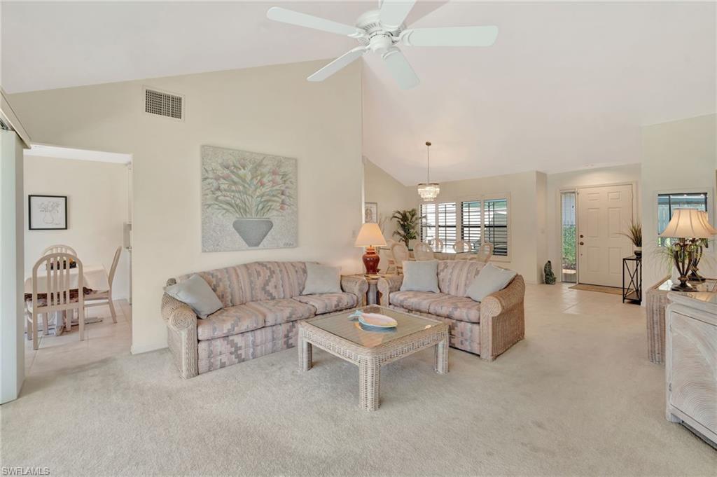 731 Reef Point Circle Naples, FL 34108 - Photo 7 of 47 a living room with furniture and a table