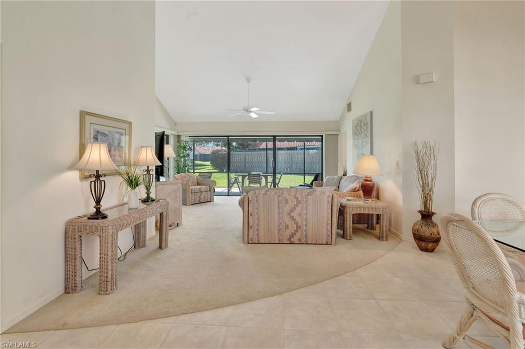 731 Reef Point Circle Naples, FL 34108 - Photo 9 of 47 a living room with furniture and a large window