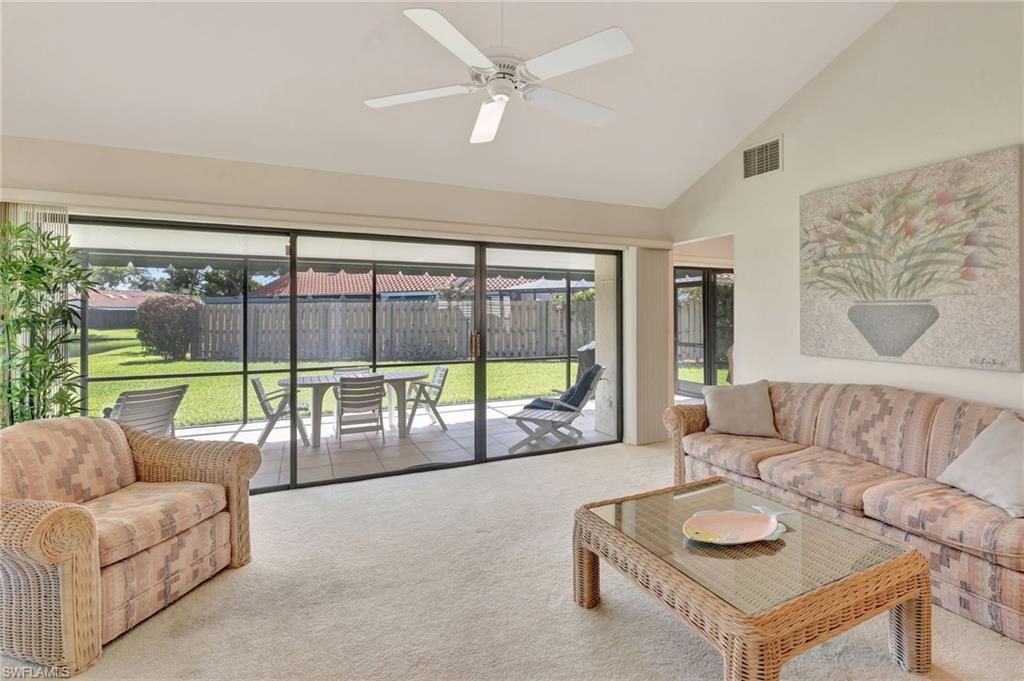 731 Reef Point Circle Naples, FL 34108 - Photo 10 of 47 a living room with furniture and a large window with outer view