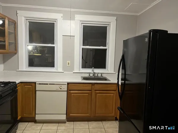 a kitchen with a sink and refrigerator