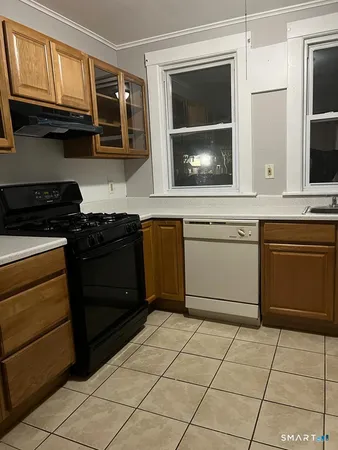 a kitchen with stainless steel appliances granite countertop a stove a microwave and a sink