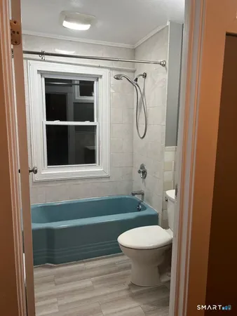 a bathroom with a toilet and a shower