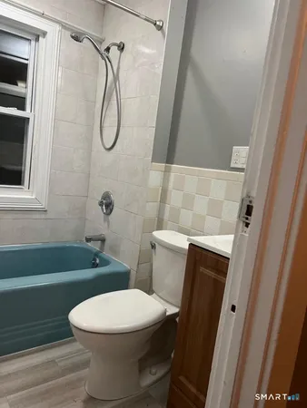 a bathroom with a toilet and a shower