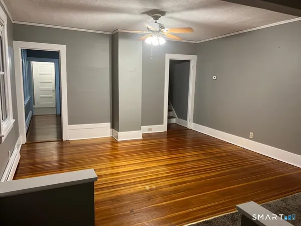 a view of a room with wooden floor
