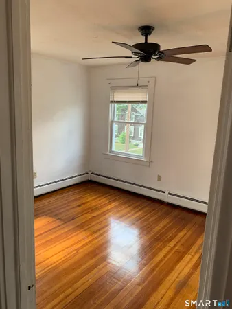 a view of a hallway and wooden floor