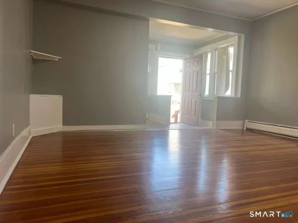 a view of a livingroom with wooden floor