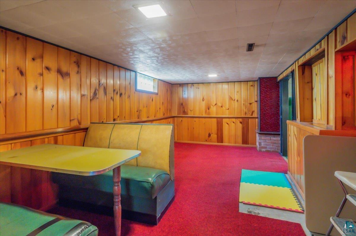 5253 Midway Road Duluth, MN 55811 - Photo 16 of 28 Living area with carpet flooring and wooden walls