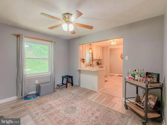a view of a living room kitchen and a wooden floor