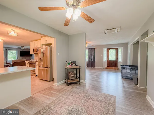 a view of an empty room with a fireplace and a window