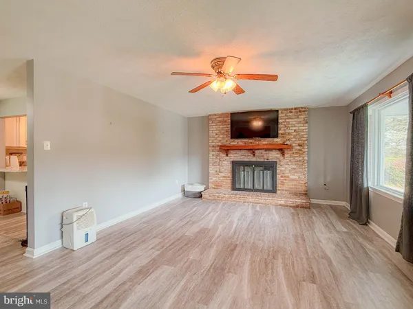 a view of a livingroom with wooden floor and window