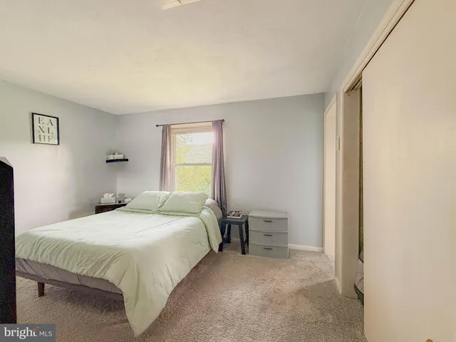 a bedroom with a large bed and a dresser