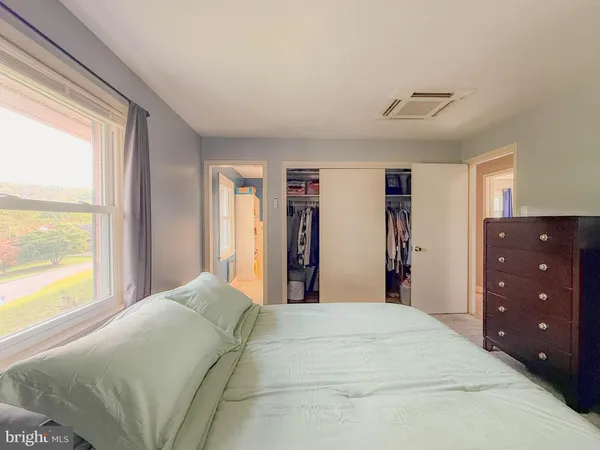 a bathroom with a sink toilet vanity and window