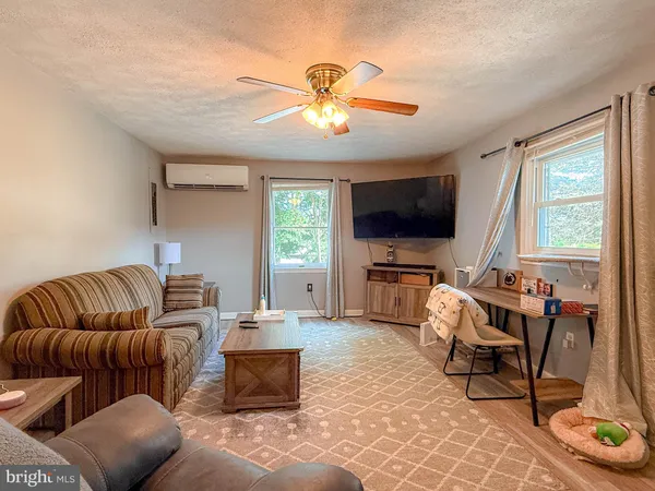 a living room with a bed and a window