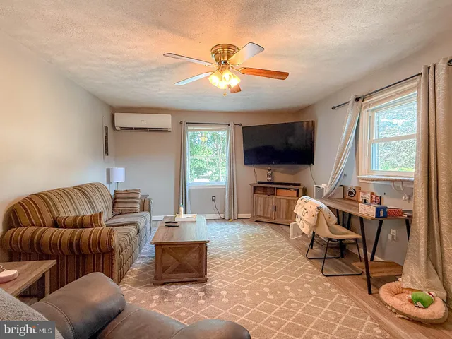 a living room with a bed and a window