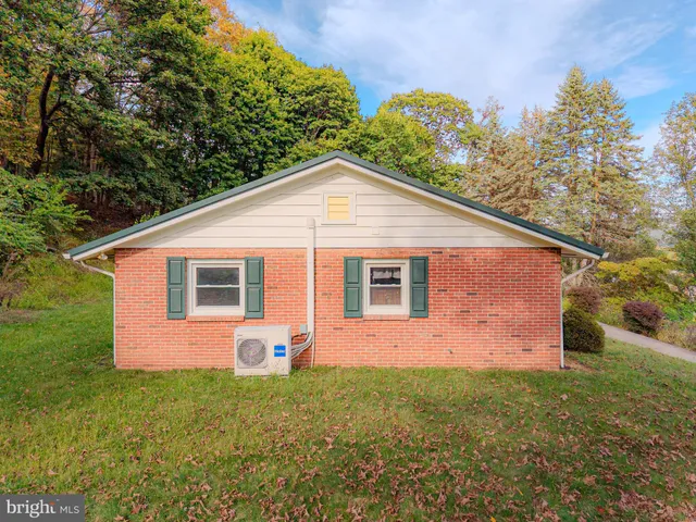 an aerial view of residential houses with outdoor space and ocean view