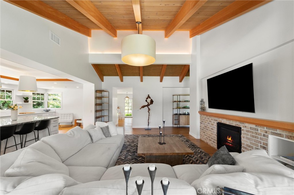 7337 La Soldadera Rancho Santa Fe, CA 92067 - Photo 13 of 60 a living room with furniture a fireplace and a flat screen tv