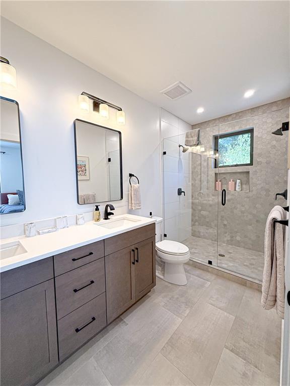825 Barnett Street Northeast Atlanta, GA 30306 - Photo 13 of 44 a bathroom with a double vanity sink toilet mirror and shower
