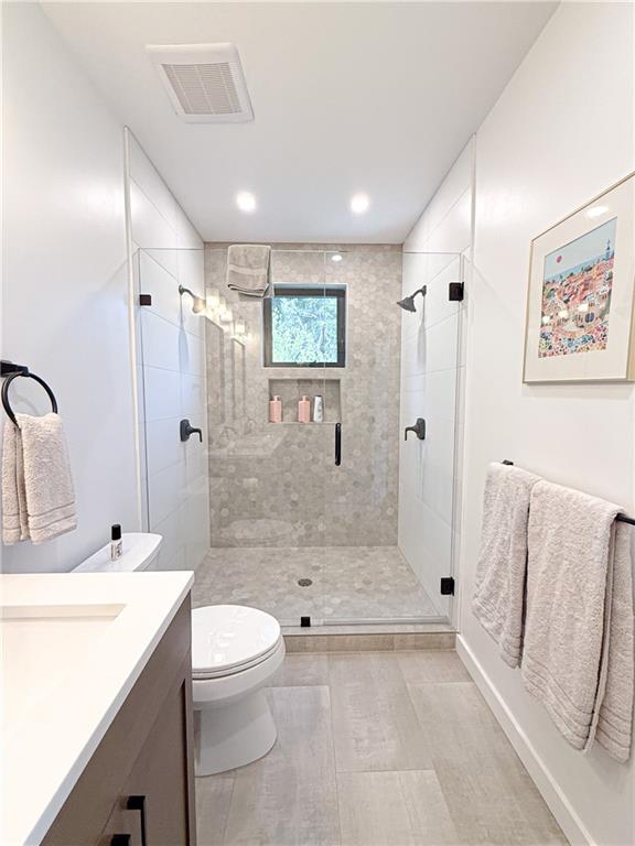 825 Barnett Street Northeast Atlanta, GA 30306 - Photo 14 of 44 a bathroom with a sink a toilet and shower