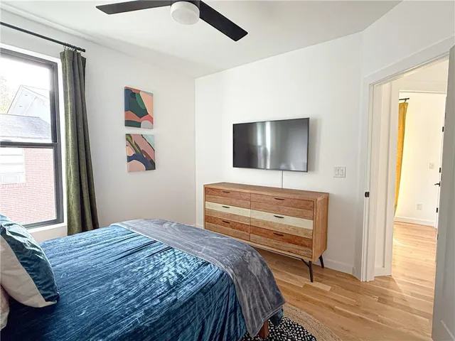 a bedroom with a bed and a flat screen tv