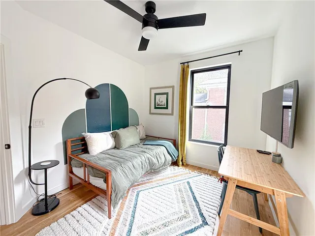 a bedroom with a bed and a flat screen tv