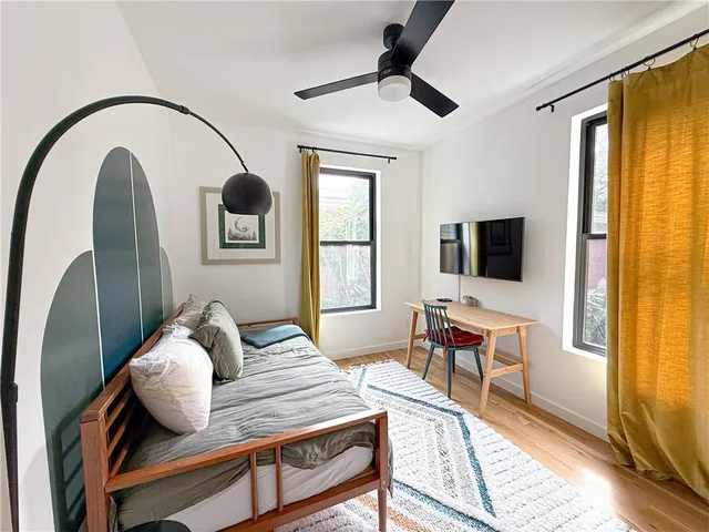 a bedroom with furniture and a window