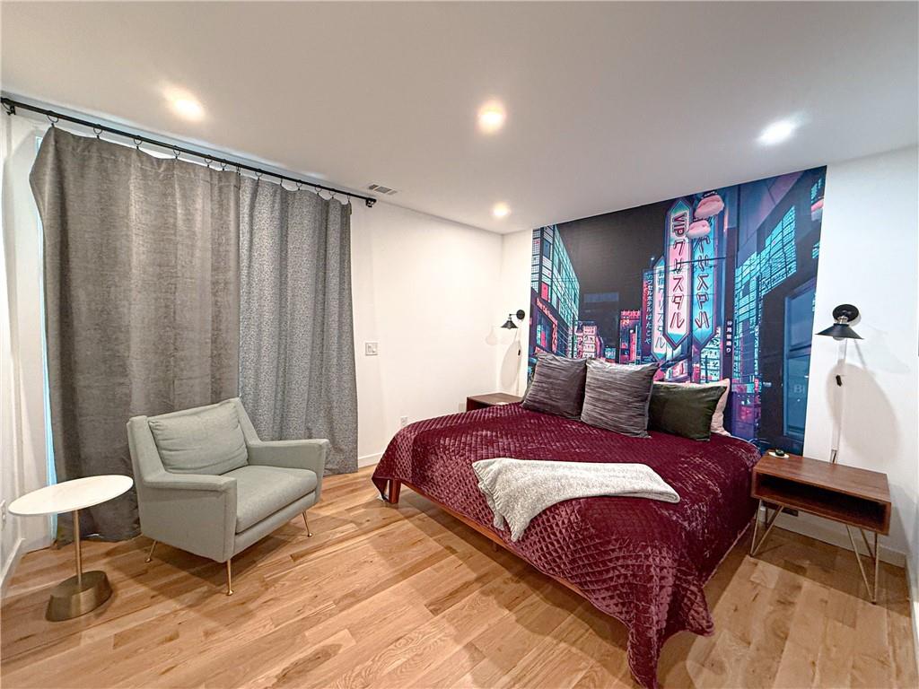 825 Barnett Street Northeast Atlanta, GA 30306 - Photo 20 of 44 a spacious bedroom with a bed and a couch