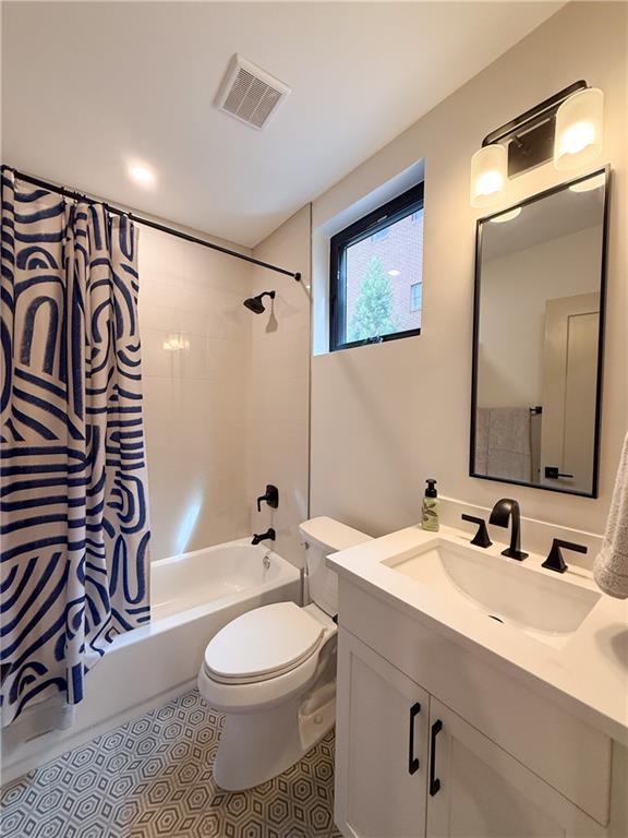 825 Barnett Street Northeast Atlanta, GA 30306 - Photo 22 of 44 a bathroom with a sink a toilet and shower