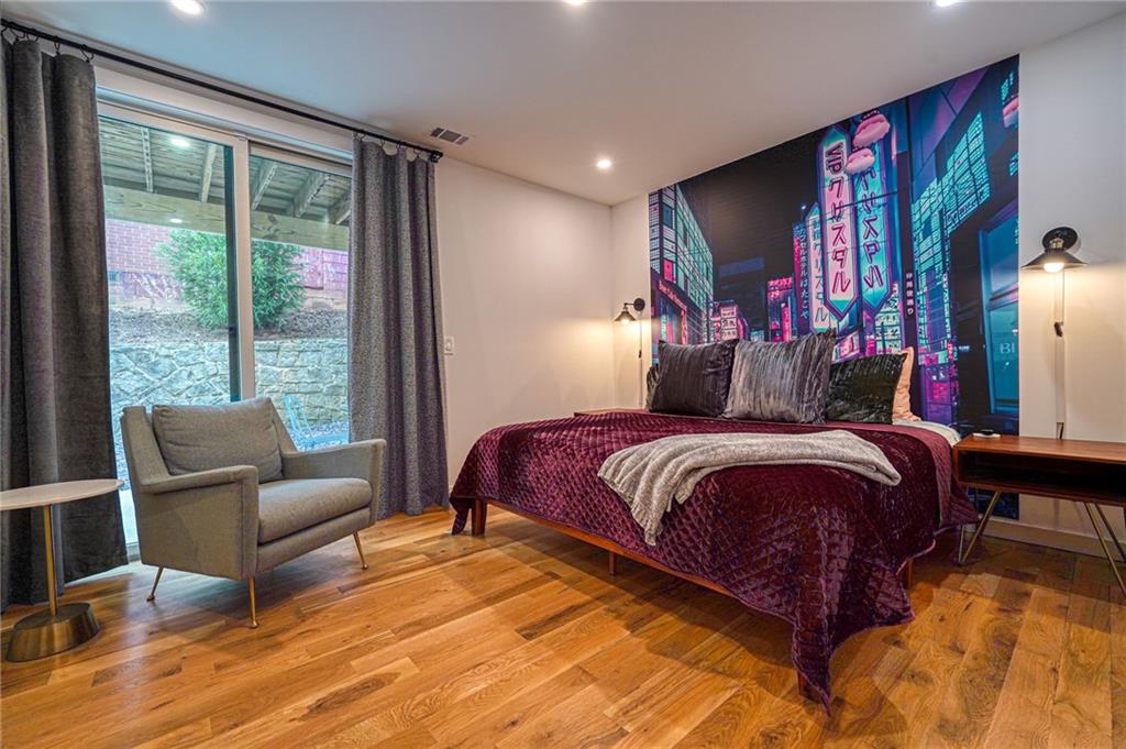 825 Barnett Street Northeast Atlanta, GA 30306 - Photo 35 of 44 a bedroom with a bed and wooden floor