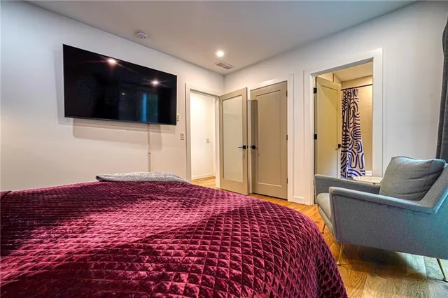 a bedroom with a bed and a television