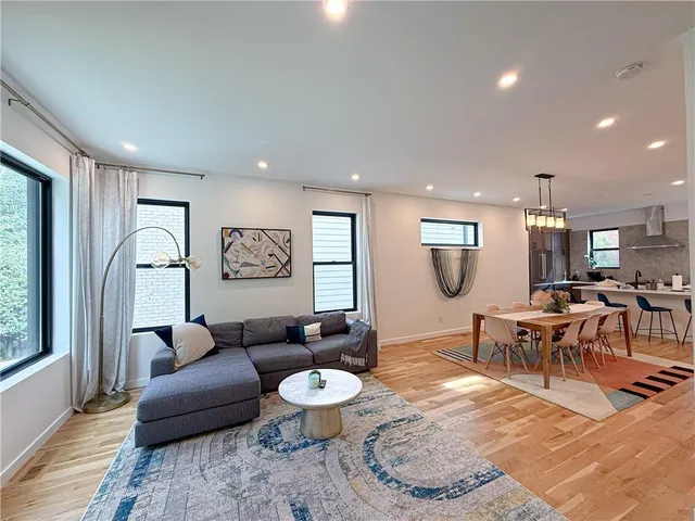 a living room with furniture a rug and a table