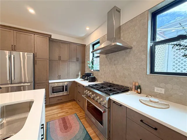 a kitchen that has a sink a stove and a refrigerator