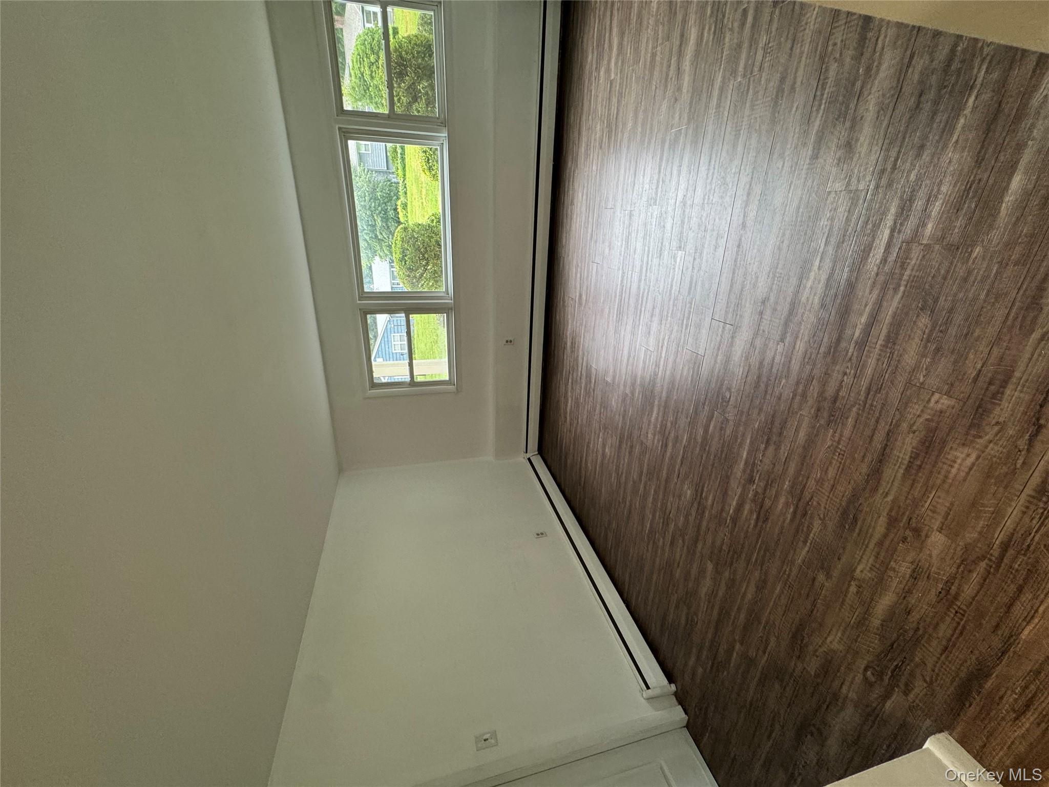 1145 Glen Road, Unit B Shrub Oak, NY 10588 - Photo 3 of 13 Spare room featuring dark wood-style floors and a baseboard heating unit