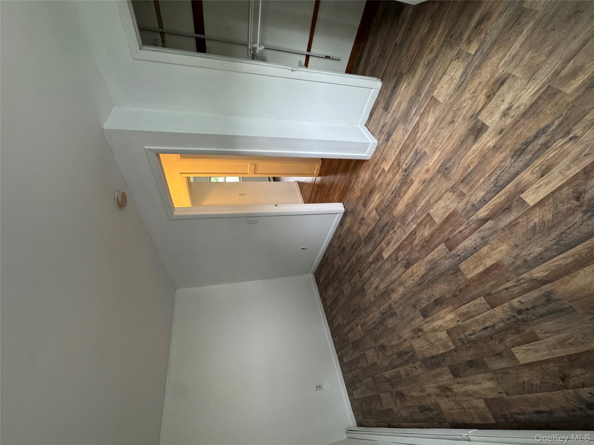 1145 Glen Road, Unit B Shrub Oak, NY 10588 - Photo 8 of 13 Unfurnished bedroom featuring dark wood finished floors and a walk in closet