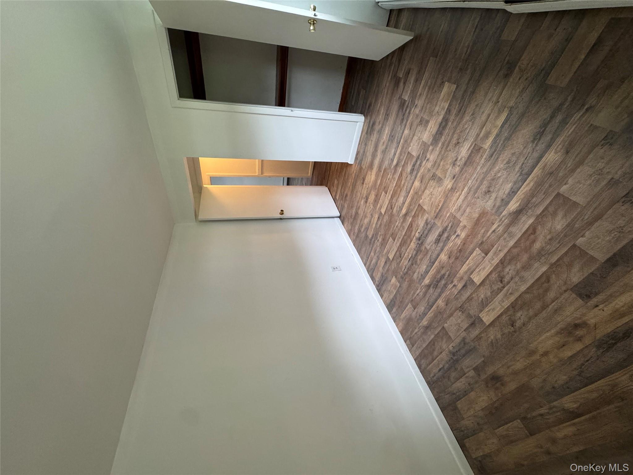 1145 Glen Road, Unit B Shrub Oak, NY 10588 - Photo 10 of 13 Unfurnished bedroom featuring dark wood-type flooring and a closet