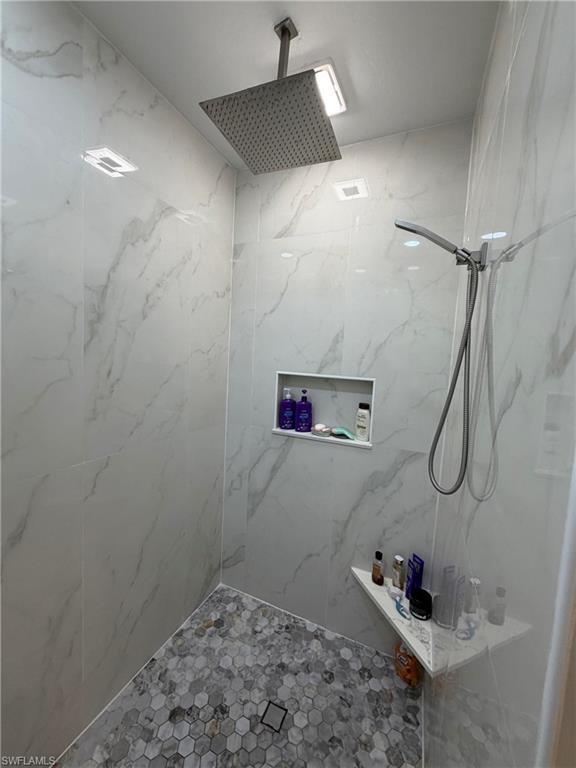 7791 Grande Pine Road Bokeelia, FL 33922 - Photo 27 of 45 a bathroom with a bathtub and shower